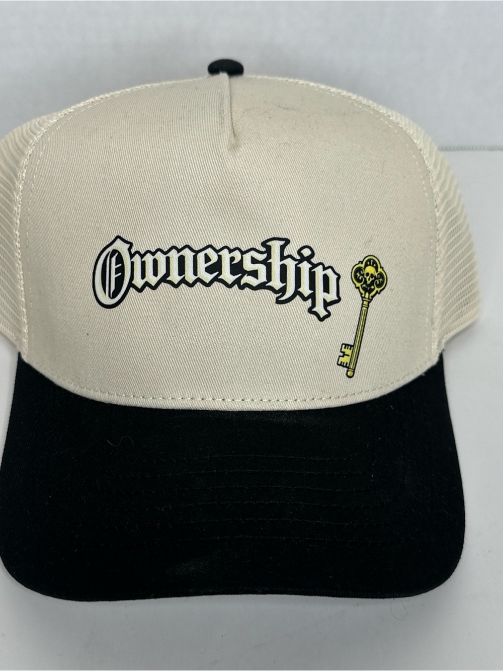 Cream and Black 'Ownership' Trucker Cap with Key Graphic